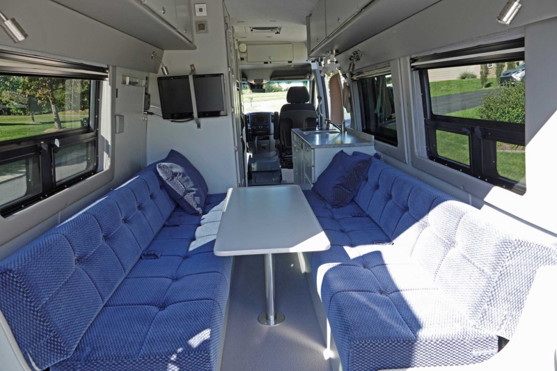 Interior of a converted van, 2016 Sprinter 170 Extended 4x2 Dually. Dinette in a dining mode.