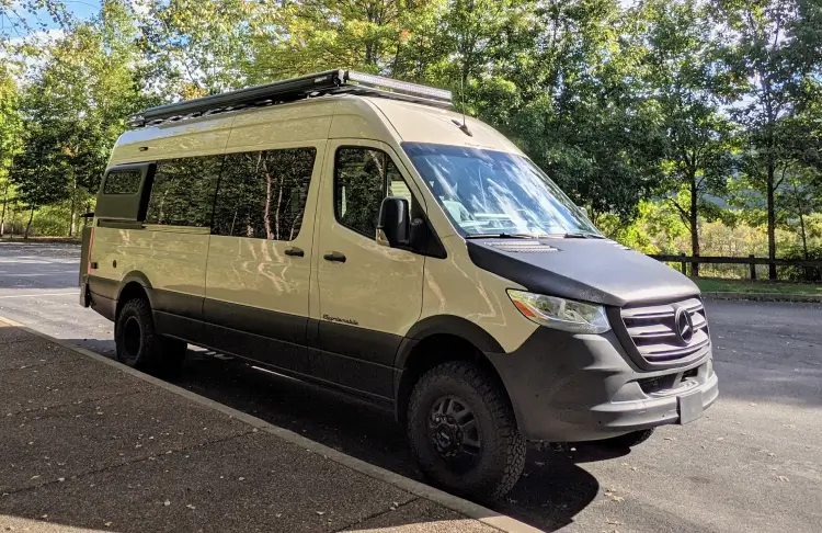 Beige converted Mercedes Sprinter van.