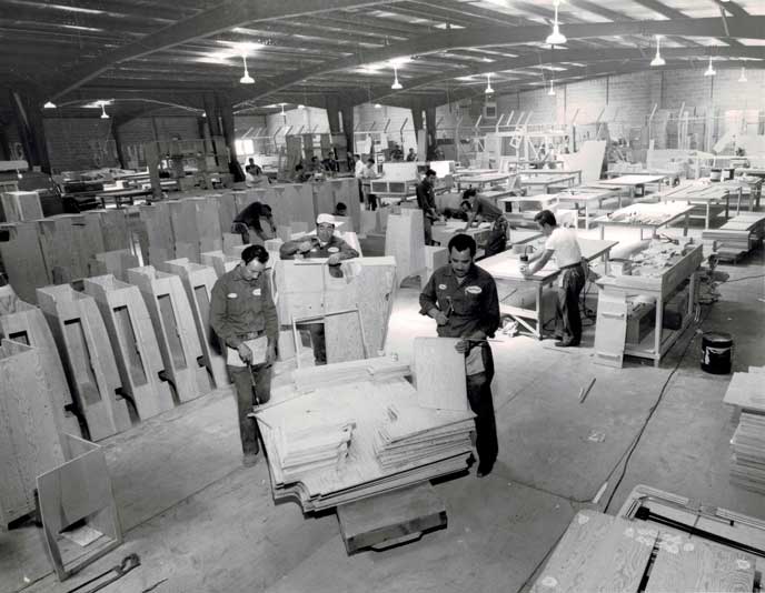 View from inside of Sportsmobile's factory. Employees working on van conversions. Picture from 1961.